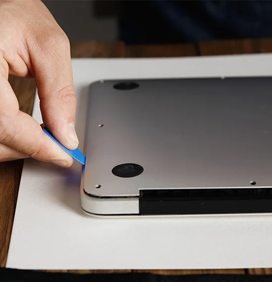 Technician performing MacBook battery replacement in London